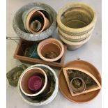 A large collection of assorted garden plant pots to include terracotta and plastic examples.