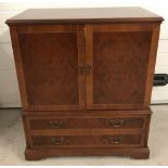 A vintage cherry coloured wooden 2 drawer, 2 door cabinet.