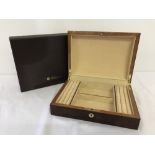 A boxed red Birdseye maple jewellery box by Walwood.