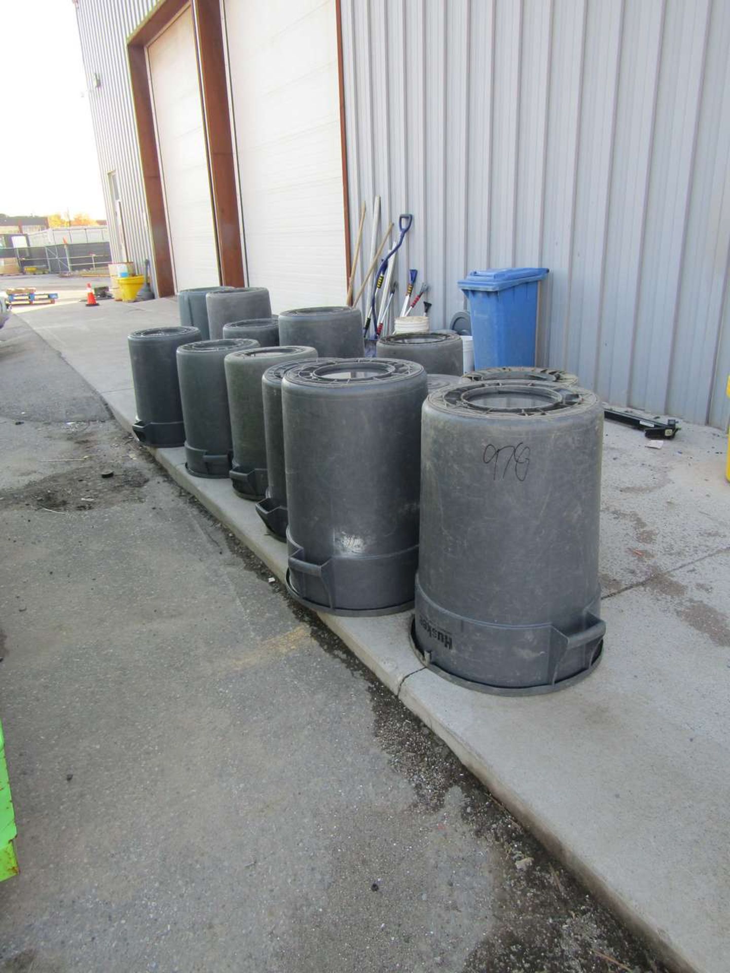 Garbage cans along outside wall
