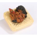 Japanese Meiji period ivory and boxwood netsuke, the carved hen with chicks above the ivory panel