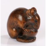 Japanese Edo period netsuke, the boxwood netsuke carved as a mouse eating a nut, it's tail curled