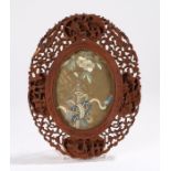 Late 19th Century Chinese Canton carved frame, carved with C scrolls, pagodas and figures, with an