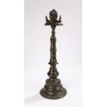 Late 19th Century Indian oil lamp of cast bronze the top surmounted with the figure of Ganesha