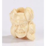 Japanese Meiji period ivory ojime bead, carved as theatrical masks, signed, 3cm high