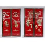 Set of four red lacquer Chinese panels, decorated with pagodas and trees above a figure, 30cm x