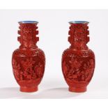 Pair of Cinnabar lacquer vases decorated with panels of flowers, with blue interiors and gilt