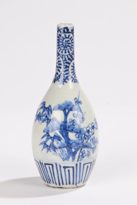 Chinese porcelain vase, in blue and white with a slender neck above a tree decorated body,