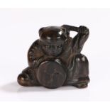 Japanese Meiji period netsuke, carved as a boy playing a drum, 3.5cm high