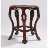Chinese hardwood stand, with a circular top above arched undulating legs, 19cm wide, 21cm high