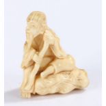 Japanese Meiji period ivory netsuke, carved as a seated scholar on a rock, 4.5cm high