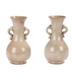 Pair of 18th century celadon vases, with flared rims above pierced handles and bulbous lower