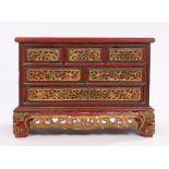 Chinese table top cabinet, in red and heightened in gilt, the rectangular top above six drawers