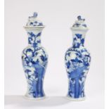 Two Japanese blue and white porcelain vases, with dog of fo form finials to the domed covers, the