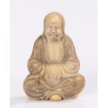 Chinese soap stone figure of a scholar, the robed seated figure with arms crossed within the robe,