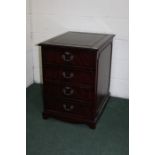 Mahogany veneered filing cabinet, with tooled green leatherette inset top above two drawers, on