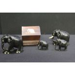 Collection of ebony elephants, together with an elephant decorated cigarette dispenser, (5)