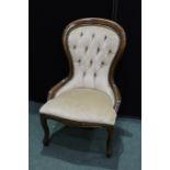 Victorian style nursing chair, the spoon form back with button upholstery, serpentine front seat, on
