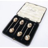 Set of six George V silver coffee spoons, with black coffee bean decorated handles, housed in a