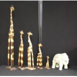 Graduated set of five carved wooden giraffes, reconstituted stone elephant (6)