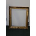 Gilt picture frame with hessian mount and pierced scroll decoration, 78cm x 68cm