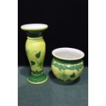 Porcelain jardiniere and pedestal, with foliate decoration on a yellow and green ground, 82.5cm high