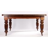 Edwardian extending dining table, with canted corners on turned reeded legs and castors, together