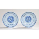 Pair of 18th Century porcelain dishes, the central fields decorated with stylised flower heads, with
