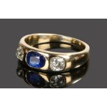 Sapphire and diamond set ring, the central oval sapphire flanked by a diamond to either side at