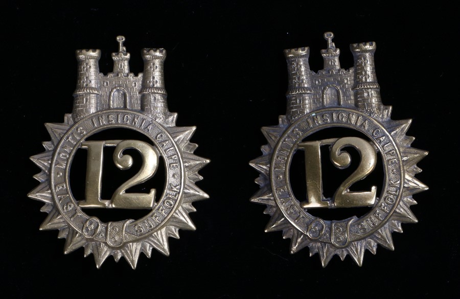 Two 12th Regiment of Foot (Suffolk Regiment) glengarry badges, two loops to the reverse,