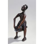 African carved figure, with long arms playing a drum, 34cm high