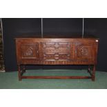 Jacobean style oak dresser base, with two central geometric moulded doors flanked by two cupboards