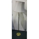 Brass standard lamp with twisted stem, on a stepped circular plinth base