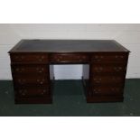 Mahogany pedestal desk, with blue tooled leatherette inset top, three frieze drawers, cupboards with