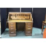 Early 20th Century oak roll top desk, with a tambour fall above drawers to the base, 121cm wide