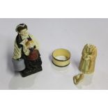 French pottery figure, of a lady holding a dog and two bags, together with a Royal Worcester Snuffer