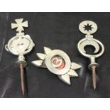 Three white metal horse ornaments for use on horse harness.