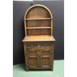 Mid 20th Century small oak dresser with arched plate rack above a frieze drawer and two panelled