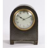 20th Century Castle Pewter clock, the arched hammered case with bead and dot edge raised on shaped