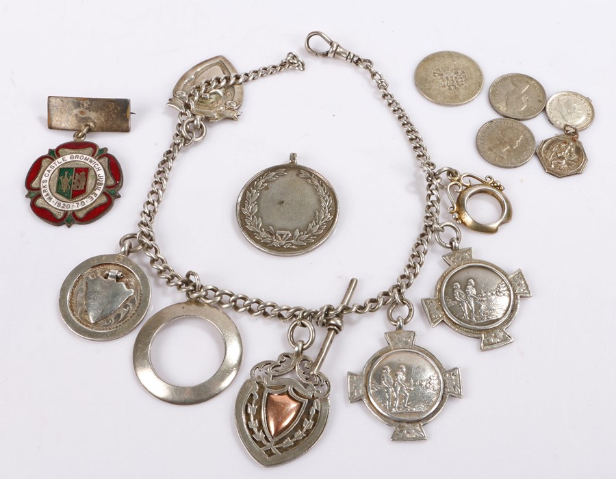 Silver watch chain set with six silver quoits prizes and a shield shaped pendant, 2.4oz, together