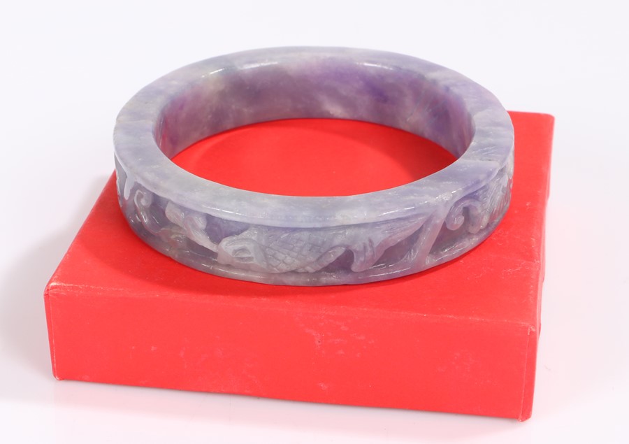 Lavender jade bangle, carved with fish and scrolls