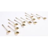 Set of ten continental silver gilt teaspoons, with mask and scroll cast finials, twisted stems,