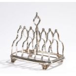 Victorian silver toast rack, London 1852, maker John Evans II, with pierced scroll finial and six