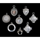 Eight early 20th Century silver watch chain fobs, to include two in the form of quoits, two quoits