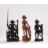 Three Burmese wood figures, carved as a fisherman with rod and fish, together with two figures