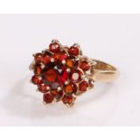 9 carat gold garnet set ring, in the form of a flower head, ring size I/1/2