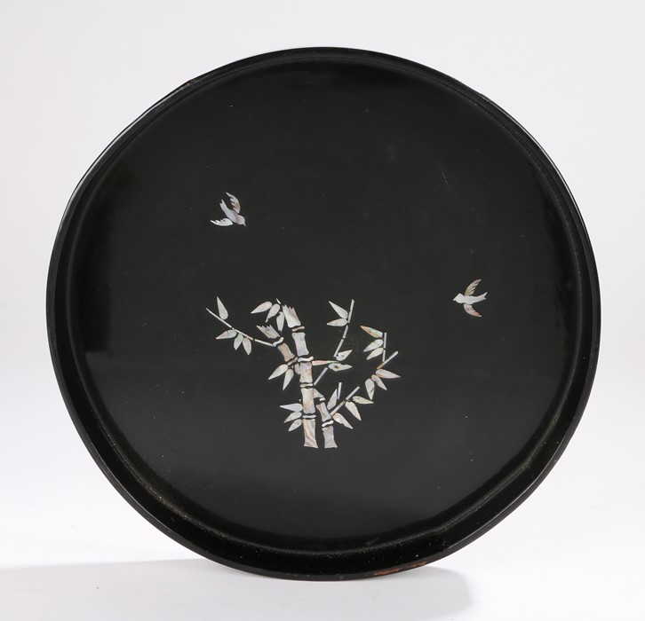 Chinese black lacquer tray, of circular form, the central field with mother of pearl inlay depicting