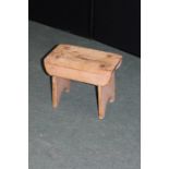 Small rustic pine stool, with rectangular seat on silhouette end supports