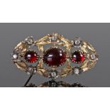 Victorian garnet and diamond set brooch, the cabochon trio of garnets with eight diamonds set to