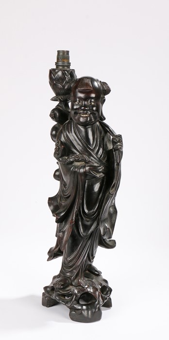 Republic of China era hardwood lamp carved as a figure of a boy holding a ruyi sceptre and fruits